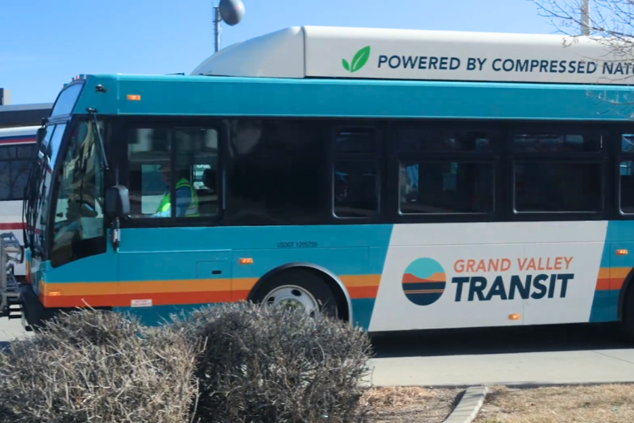 A large blue and white Grand Valley Transit bus drives out of the downtown transfer station in Grand Junction. 